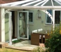 French doors leading to covered patio garden area by Mendip Conservatories